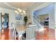 Elegant dining room featuring hardwood floors, a chandelier, and a decorative tray ceiling at 3848 Burnage Hall Rd, Harrisburg, NC 28075