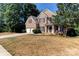 Traditional brick home with a well-manicured lawn, two-car garage, and inviting front porch at 3848 Burnage Hall Rd, Harrisburg, NC 28075