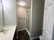 Practical bathroom features a shower with sliding glass door and vanity with marble countertop at 6017 Treetop Ct, Charlotte, NC 28212
