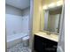 Functional bathroom features a tub with tile surround, a sleek vanity, and attractive flooring at 6017 Treetop Ct, Charlotte, NC 28212