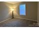 Cozy bedroom with soft carpet, neutral walls, and a large window to let the sunshine in at 6017 Treetop Ct, Charlotte, NC 28212