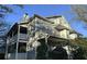 Two-story home featuring a front porch and upper balcony with white wooden railings and gray siding at 6017 Treetop Ct, Charlotte, NC 28212