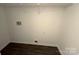 Compact laundry room with wood-look floors and utility connections at 6017 Treetop Ct, Charlotte, NC 28212