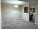Carpeted living room with a pass-through to the kitchen with views into the kitchen at 6017 Treetop Ct, Charlotte, NC 28212