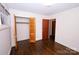 Bedroom with hardwood floors, closet, and additional door at 6433 Montpelier Rd, Charlotte, NC 28210