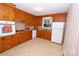 Kitchen with wood cabinets, granite counters and tile floor at 6433 Montpelier Rd, Charlotte, NC 28210