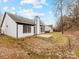 Exterior backyard showcasing a freshly painted home, open patio, and partial lawn at 10519 Brawley Ln, Charlotte, NC 28215