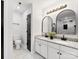 Bathroom features double sinks, granite countertops, modern light fixtures, and marble-look tile at 10519 Brawley Ln, Charlotte, NC 28215