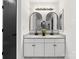 Modern bathroom with double sinks, granite countertops, arched mirrors, and black hardware at 10519 Brawley Ln, Charlotte, NC 28215