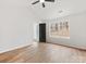 Bright bedroom with a ceiling fan, wood-look floors, a black door, and a large window at 10519 Brawley Ln, Charlotte, NC 28215