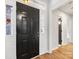 Entryway featuring a black front door, light hardwood floors, and access to other rooms at 10519 Brawley Ln, Charlotte, NC 28215