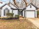 Charming single-story home featuring a well-maintained lawn, a garage, and a welcoming front entrance at 10519 Brawley Ln, Charlotte, NC 28215