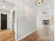 Hallway view showing wood-look flooring with an entry to a living area at 10519 Brawley Ln, Charlotte, NC 28215
