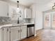 Stylish kitchen featuring stainless steel dishwasher and a mosaic tile backsplash at 10519 Brawley Ln, Charlotte, NC 28215