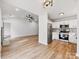 Open-concept kitchen featuring stainless steel appliances, white cabinets, and a stylish backsplash at 10519 Brawley Ln, Charlotte, NC 28215
