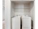 Bright laundry area with white washer and dryer and a shelf at 10519 Brawley Ln, Charlotte, NC 28215
