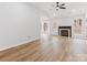 Bright living room featuring hardwood floors, a fireplace, and access to outdoor spaces at 10519 Brawley Ln, Charlotte, NC 28215