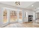 Cozy living room with a fireplace and a bay window offering natural light at 10519 Brawley Ln, Charlotte, NC 28215
