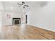 Living room boasts hardwood floors, a fireplace, and access to outdoor spaces, creating a cozy atmosphere at 10519 Brawley Ln, Charlotte, NC 28215