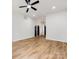 Spacious living area with hardwood floors leading to the entryway, showcasing neutral wall paint at 10519 Brawley Ln, Charlotte, NC 28215