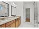 Bright bathroom features double sinks with granite countertop and a glass enclosed shower at 1074 Kinship Dr # 110, Lancaster, SC 29720