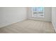 Empty bedroom with light carpet, window, and white walls at 1074 Kinship Dr # 110, Lancaster, SC 29720