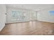 Bright living room featuring hardwood floors, large windows, and a glass door at 1074 Kinship Dr # 110, Lancaster, SC 29720