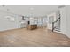 Open concept living space with island kitchen, hardwood floors, and staircase at 1074 Kinship Dr # 110, Lancaster, SC 29720