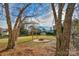 Landscaped backyard with fire pit, shed, and mature trees at 1124 Woodwinds Dr, Waxhaw, NC 28173