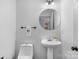 Simple, modern powder room with white pedestal sink at 1124 Woodwinds Dr, Waxhaw, NC 28173