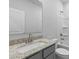 Well-lit bathroom featuring a modern vanity with a granite countertop and a white shower and tub combo at 1133 Hallman Branch Ln, Lincolnton, NC 28092