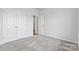 Neutral bedroom with standard closet doors, neutral carpet, and white walls, providing a blank canvas at 1133 Hallman Branch Ln, Lincolnton, NC 28092