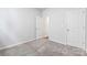 Bedroom with plush carpet, featuring two doors and a third doorway leading to other rooms at 1133 Hallman Branch Ln, Lincolnton, NC 28092