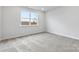 Neutral bedroom features plush carpeting, a window with natural light, and fresh white paint at 1133 Hallman Branch Ln, Lincolnton, NC 28092