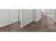 Interior shot of a hallway with wood flooring, neutral paint, and doors leading to various rooms at 1133 Hallman Branch Ln, Lincolnton, NC 28092