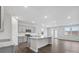 Open-concept kitchen with gray cabinets, stainless steel appliances, granite countertops, and a large island at 1133 Hallman Branch Ln, Lincolnton, NC 28092