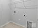 Functional laundry room with tiled floors and wire shelving for organized storage at 1133 Hallman Branch Ln, Lincolnton, NC 28092