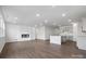 Spacious open-concept living area with hardwood floors, a modern fireplace, and a view of the kitchen at 1133 Hallman Branch Ln, Lincolnton, NC 28092