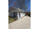 A lovely single-story home with an expansive driveway on a sunny day at 1313 Eastway Dr, Charlotte, NC 28205