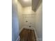 Small laundry room with wood-style floors, wire rack, and utility hook-ups at 1313 Eastway Dr, Charlotte, NC 28205