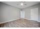 This neutral bedroom features hardwood floors and a ceiling fan at 3007 Buffett Ln, Monroe, NC 28110