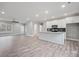 A modern open-concept kitchen featuring a center island with white cabinets, granite countertops, and stainless appliances at 3007 Buffett Ln, Monroe, NC 28110