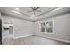 Main bedroom featuring a trey ceiling, a fan, and a window with a view into the kitchen at 3007 Buffett Ln, Monroe, NC 28110