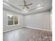 Spacious main bedroom featuring trey ceiling, a fan, and large windows with a view at 3007 Buffett Ln, Monroe, NC 28110