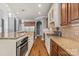Spacious kitchen with stainless steel appliances, granite countertops, and beautiful hardwood floors at 3853 Gordon St, Terrell, NC 28682