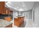 Kitchen with a central island, granite countertops, stainless steel refrigerator, and white tile floors at 3853 Gordon St, Terrell, NC 28682