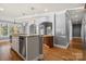 Open kitchen with wood floors, granite countertops, modern appliances, and arched entryway to other rooms at 3853 Gordon St, Terrell, NC 28682