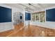 Elegant living room with hardwood floors, wainscoting, and large windows at 3853 Gordon St, Terrell, NC 28682