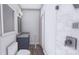 Bathroom with a walk-in shower, wood-look flooring and blue vanity at 428 Dover Ave, Charlotte, NC 28209