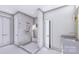 A modern bathroom features marble-style tile, a glass-enclosed shower, and gold fixtures at 428 Dover Ave, Charlotte, NC 28209